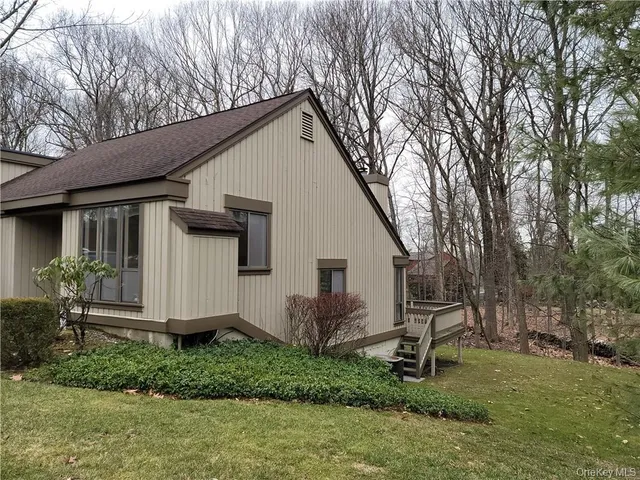 a view of backyard with potted plants and large tree