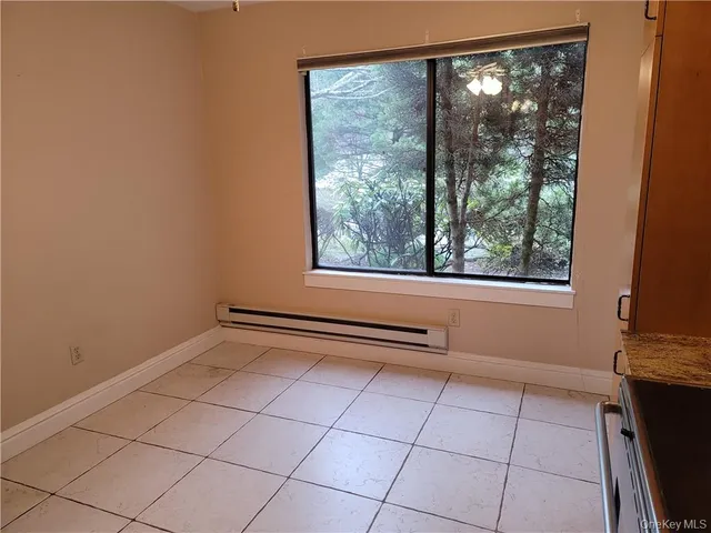a view of a livingroom with an empty space and a window