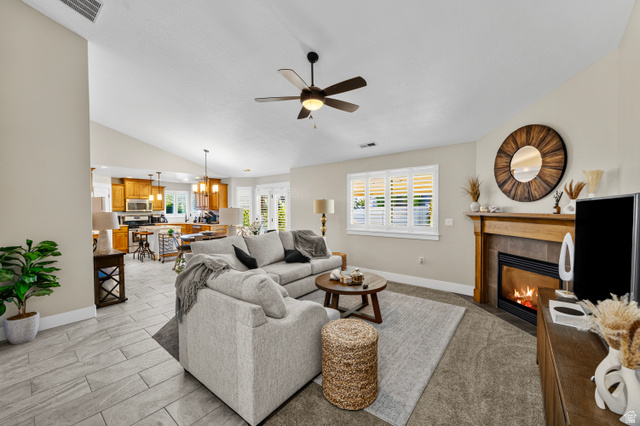564 Spring Meadow Lane Farmington, UT 84025 - Photo 5 of 31 Vaulted ceilings, wood-finish flooring, ceiling fan, fireplace with wood mantel, and interior window shutters