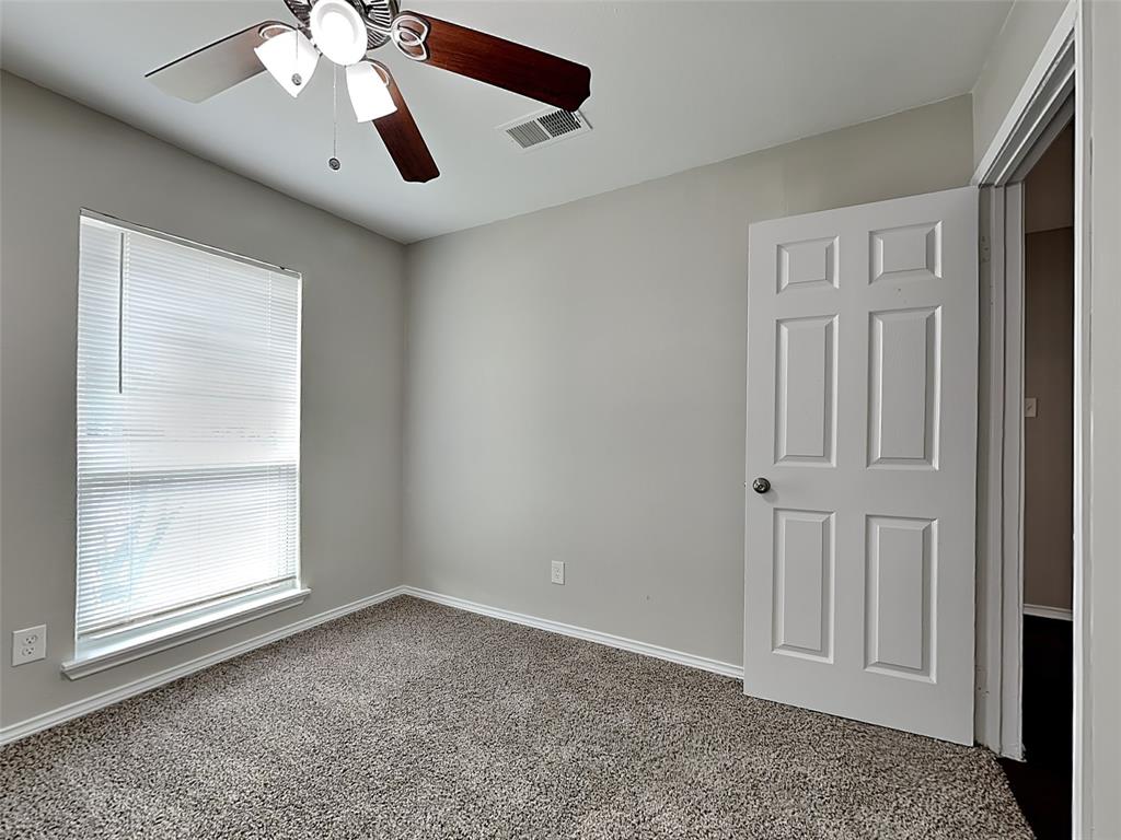 7621 Pebble Beach Drive Rowlett, TX 75088 - Photo 13 of 20 an empty room with windows and fan