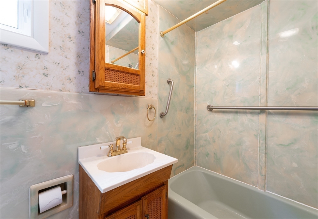 86 Epping Street Lowell, MA 01852 - Photo 11 of 41 a bathroom with a sink a bathtub and a shower