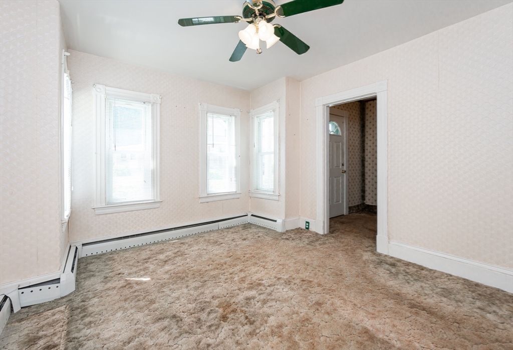 86 Epping Street Lowell, MA 01852 - Photo 16 of 41 a view of an empty room with window and chandelier fan