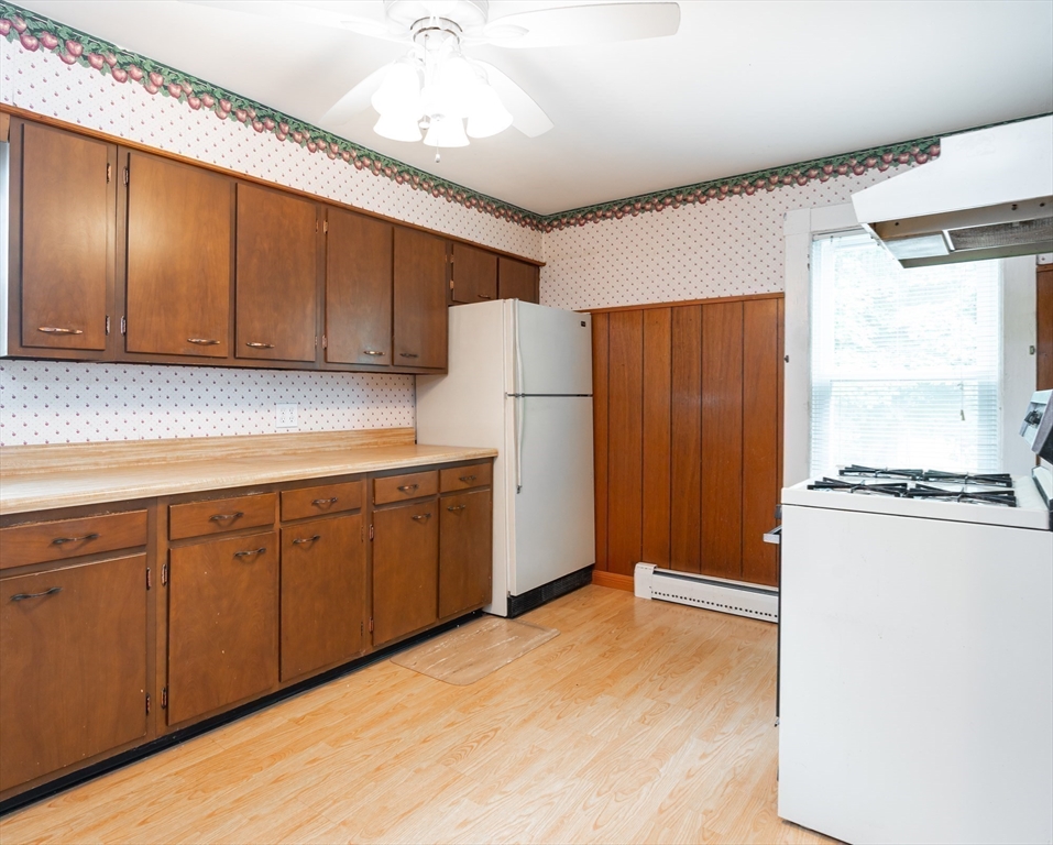 86 Epping Street Lowell, MA 01852 - Photo 4 of 41 a kitchen with a refrigerator a stove a sink and cabinets