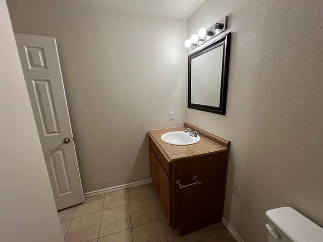 a bathroom with a sink toilet and mirror