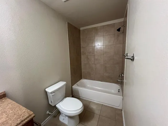 a bathroom with a toilet and shower