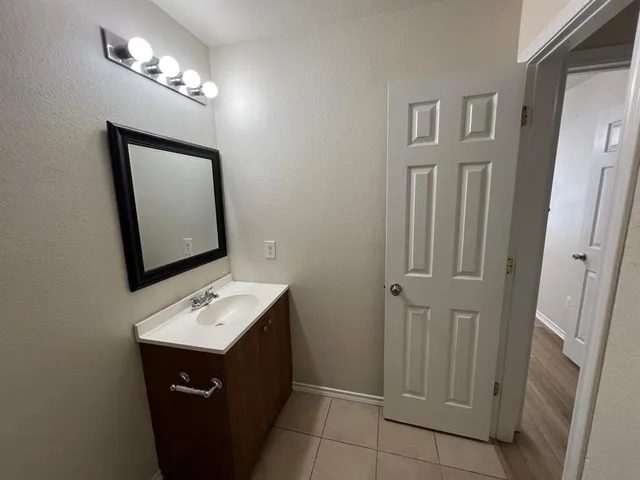 a bathroom with a sink vanity and a mirror