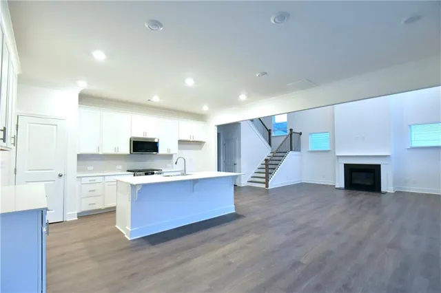 a view of kitchen with cabinets and wooden floor