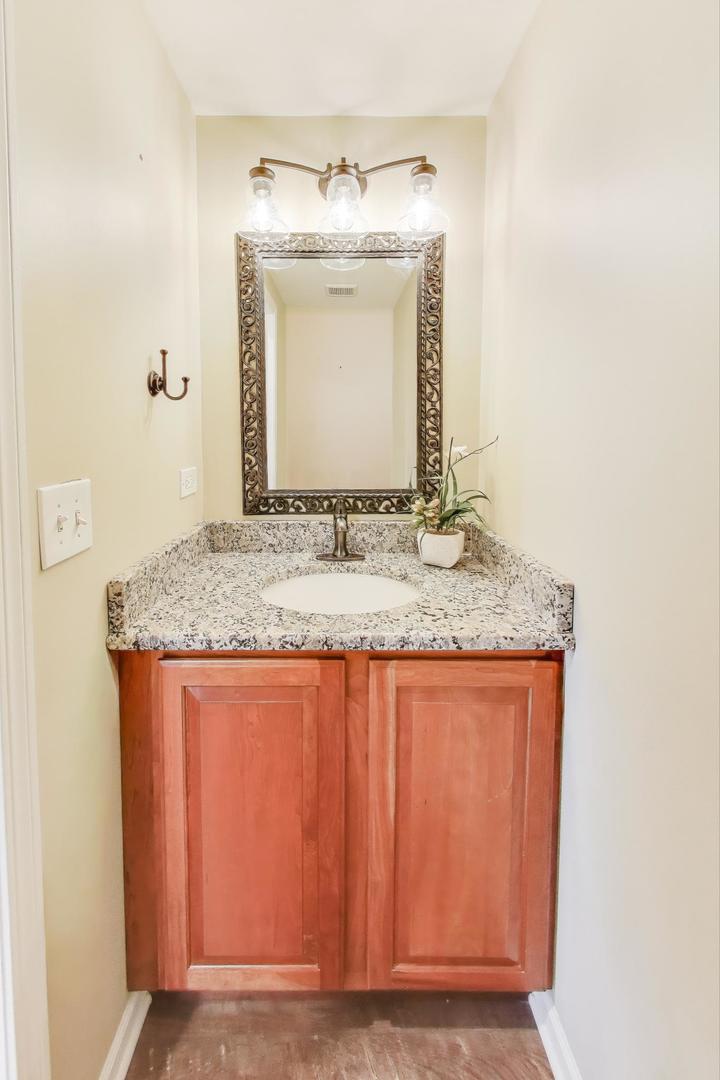 2304 Stonegate Road Algonquin, IL 60102 - Photo 16 of 42 a view of bathroom with granite countertop sink and a mirror