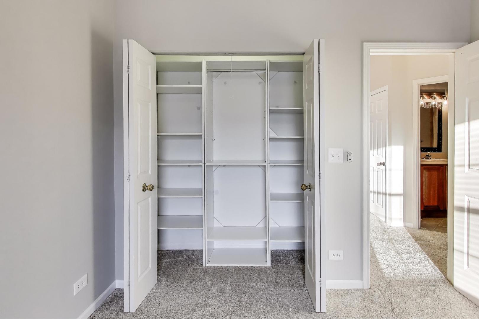 2304 Stonegate Road Algonquin, IL 60102 - Photo 29 of 42 a view of walk in closet with empty racks