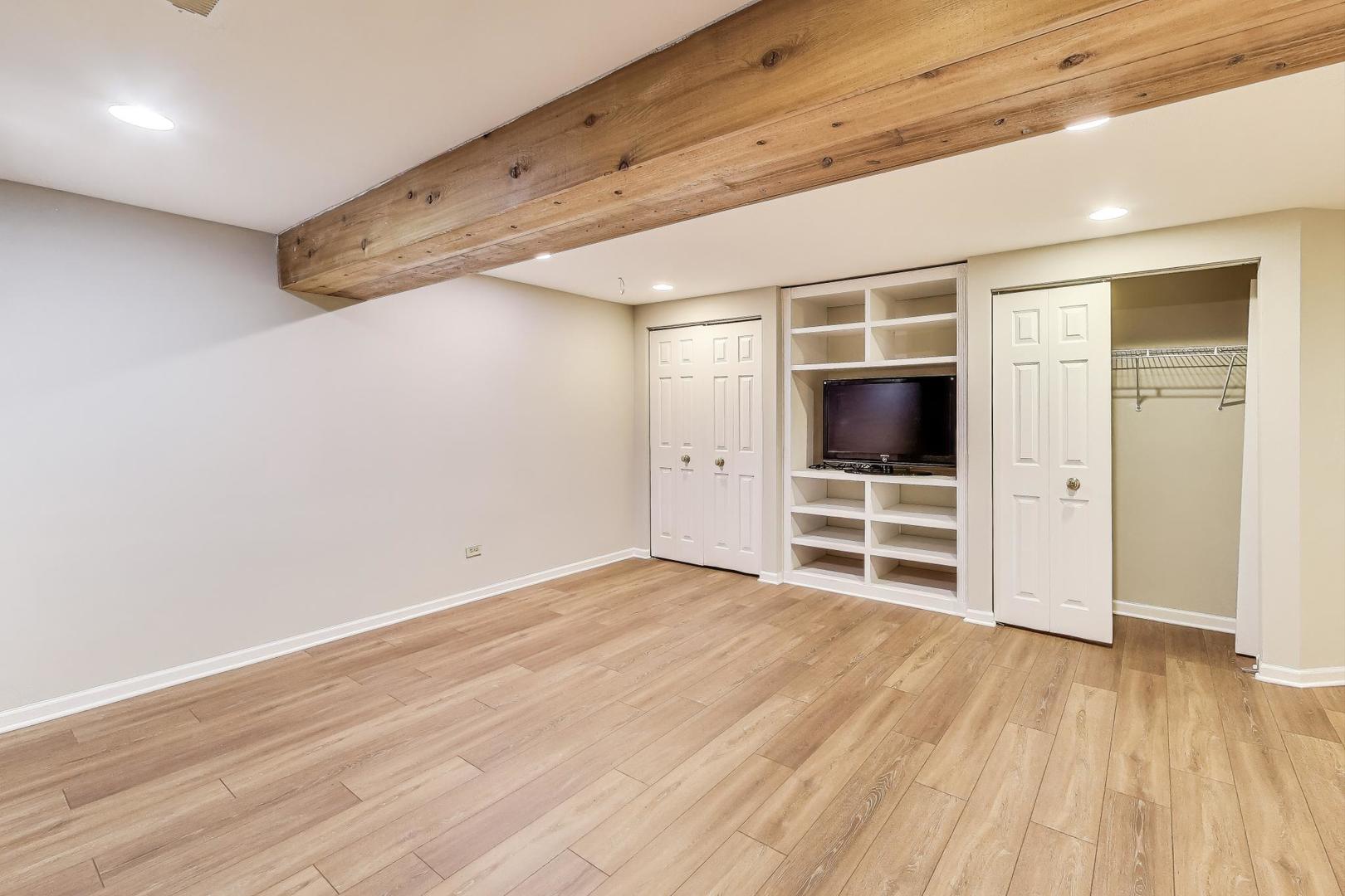 2304 Stonegate Road Algonquin, IL 60102 - Photo 35 of 42 a view of an empty room with wooden floor closet and windows