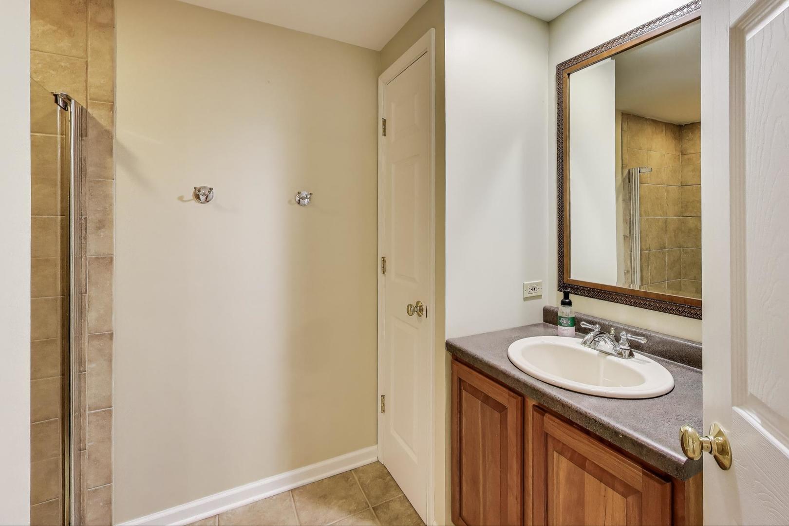2304 Stonegate Road Algonquin, IL 60102 - Photo 36 of 42 a bathroom with a sink and a mirror
