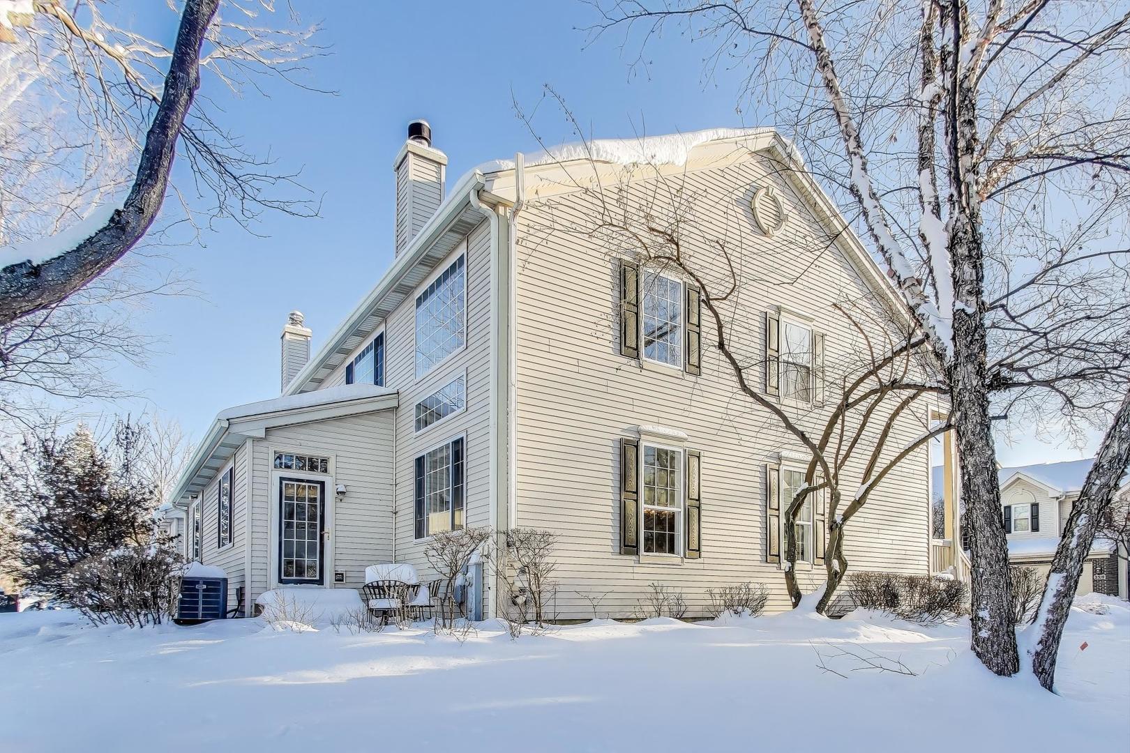 2304 Stonegate Road Algonquin, IL 60102 - Photo 4 of 42 a view of a white house with a large tree