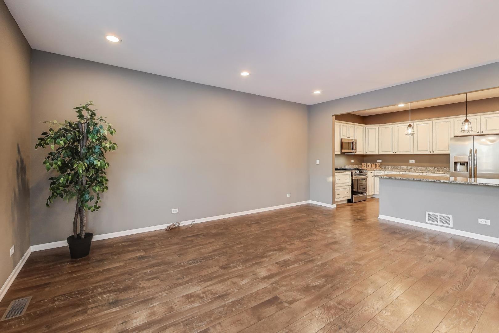 2304 Stonegate Road Algonquin, IL 60102 - Photo 9 of 42 a view of kitchen with kitchen island a counter top space a stove and wooden floor