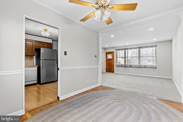 a kitchen with stainless steel appliances granite countertop a refrigerator a stove a sink and a microwave