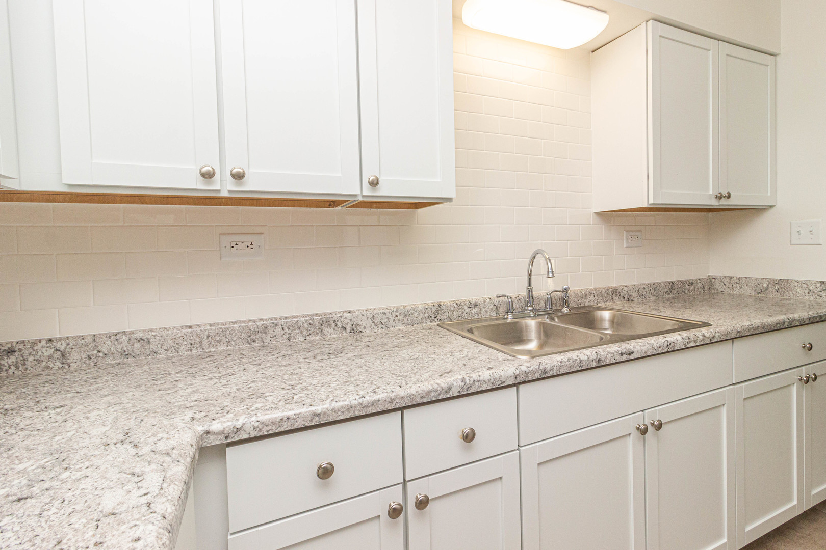 4819 West Engle Road, Unit 2D Alsip, IL 60803 - Photo 11 of 25 a kitchen with granite countertop white cabinets and a sink