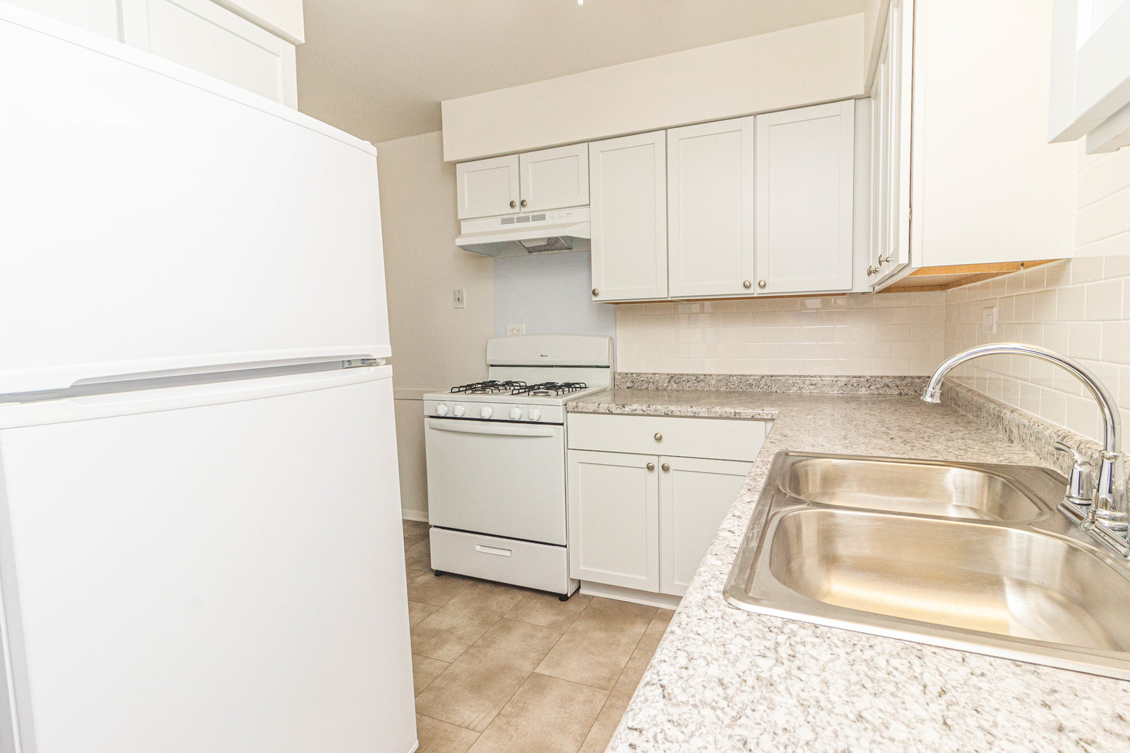 4819 West Engle Road, Unit 2D Alsip, IL 60803 - Photo 12 of 25 a kitchen with granite countertop a sink and a stove top oven
