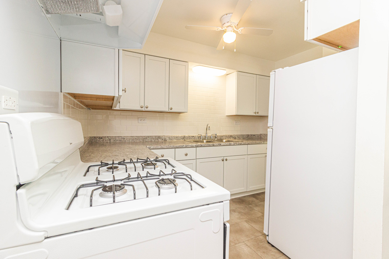 4819 West Engle Road, Unit 2D Alsip, IL 60803 - Photo 13 of 25 a kitchen with a white stove top oven and white cabinets