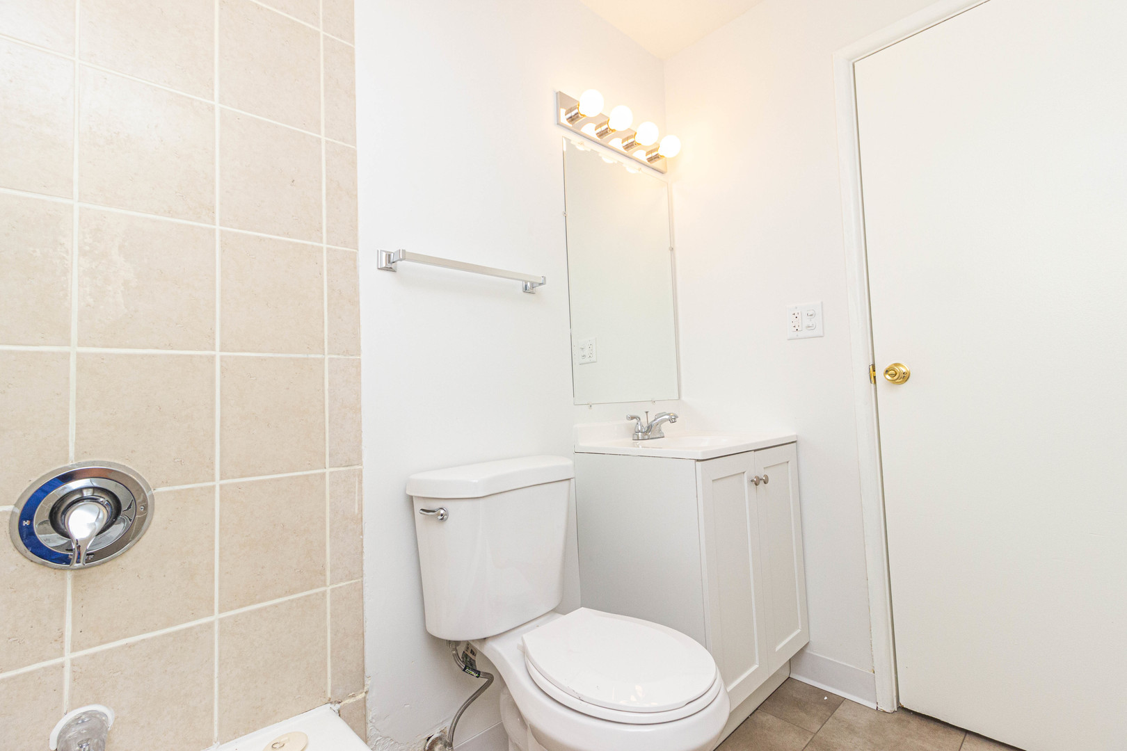 4819 West Engle Road, Unit 2D Alsip, IL 60803 - Photo 16 of 25 a white toilet sitting next to a bathroom sink