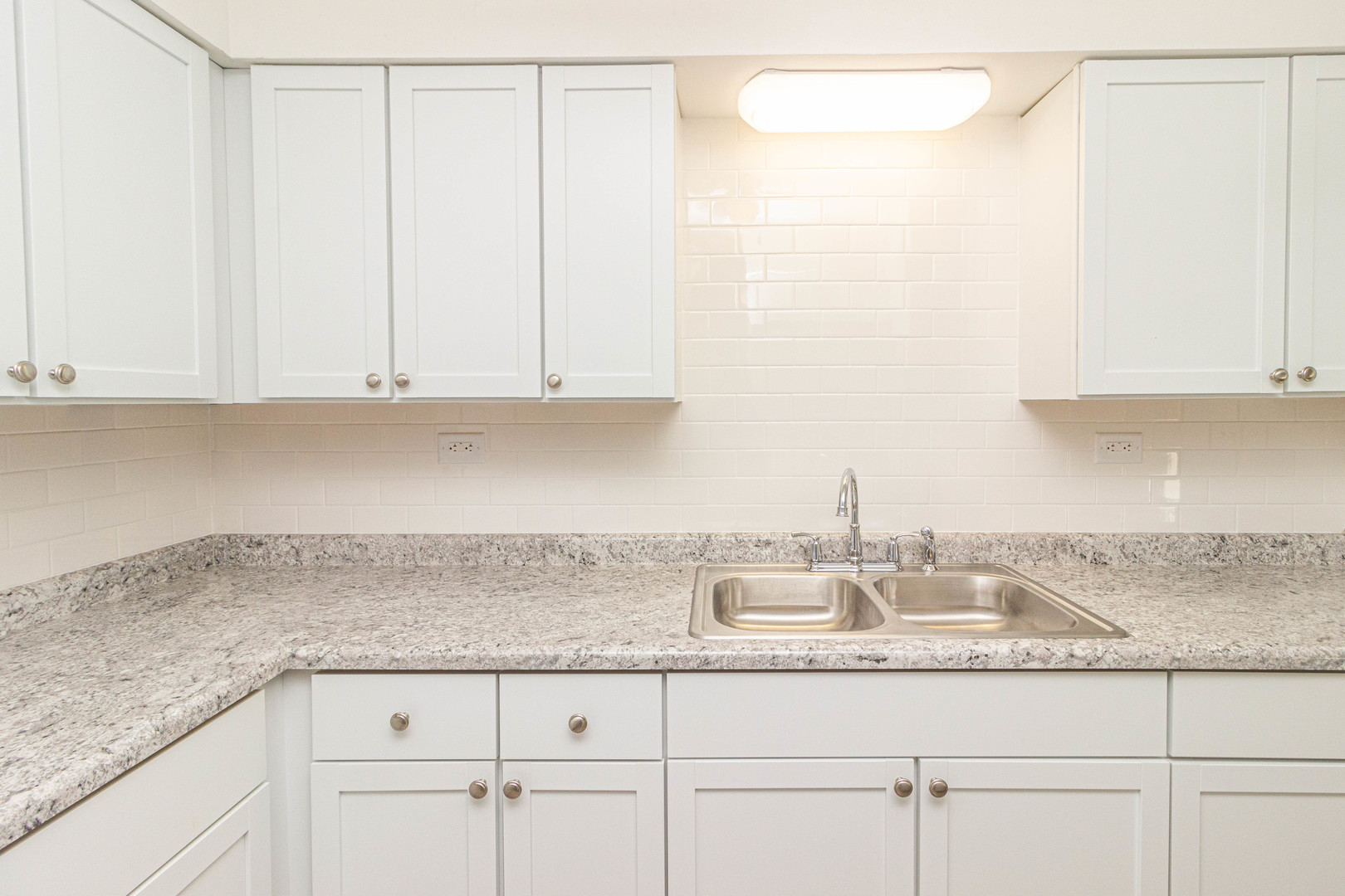 4819 West Engle Road, Unit 2D Alsip, IL 60803 - Photo 10 of 25 a kitchen with granite countertop white cabinets and a white sink
