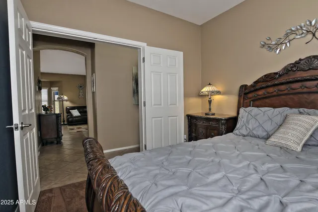 a bedroom with a bed and a mirror