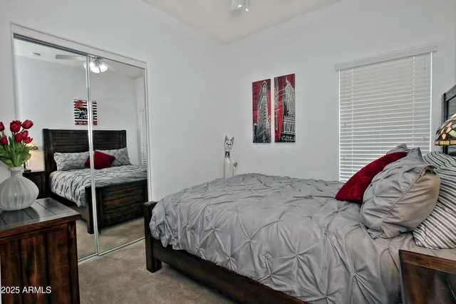 a bedroom with a bed and a dresser in it