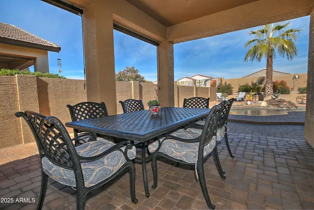a view of a patio with a table and chairs