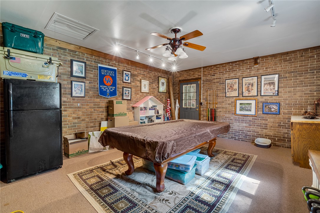 2817 Providence Church Road Anderson, SC 29626 - Photo 25 of 35 A versatile bonus room showcasing a blend of rustic brick walls and soft carpet flooring, perfect for recreation.