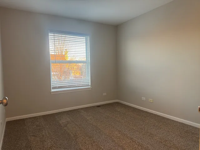 an empty room with wooden floor and sliding door
