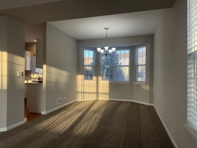 a view of wooden floor and a chandelier in a room