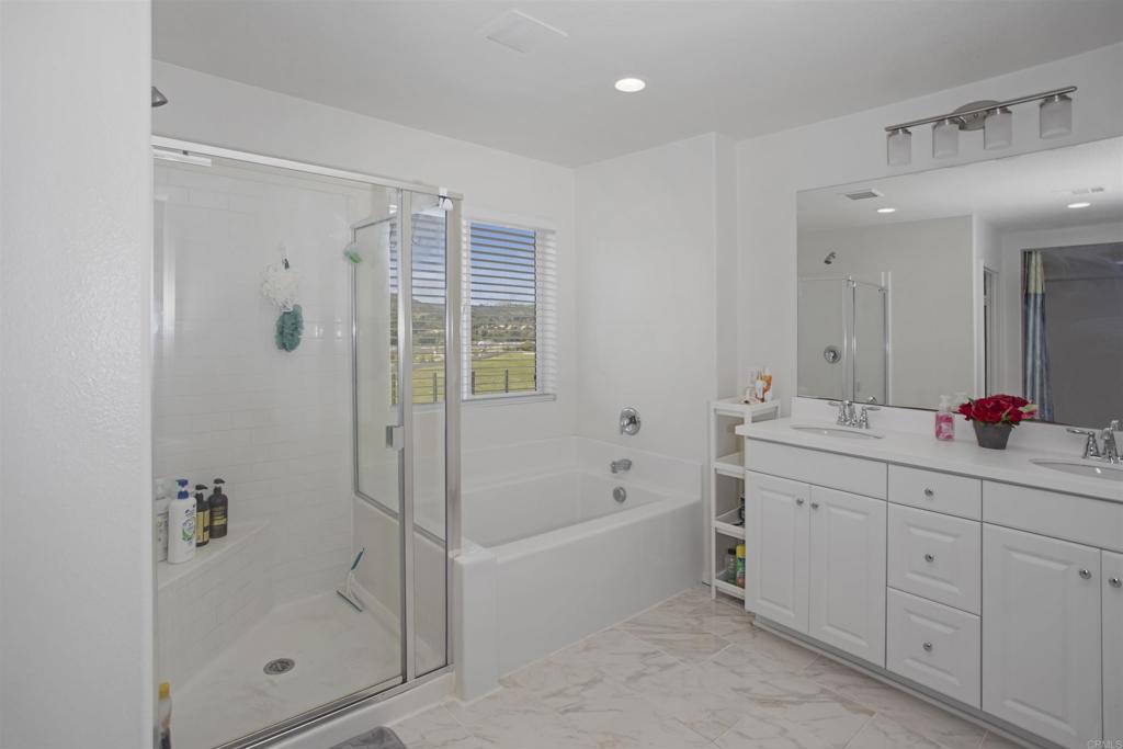 35652 Asturian Way Fallbrook, CA 92028 - Photo 16 of 34 a bathroom with a tub sink shower and mirror
