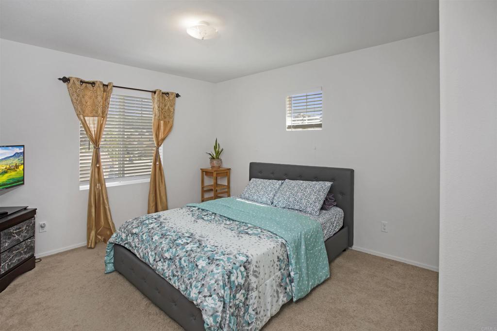 35652 Asturian Way Fallbrook, CA 92028 - Photo 17 of 34 a bedroom with a bed and a window