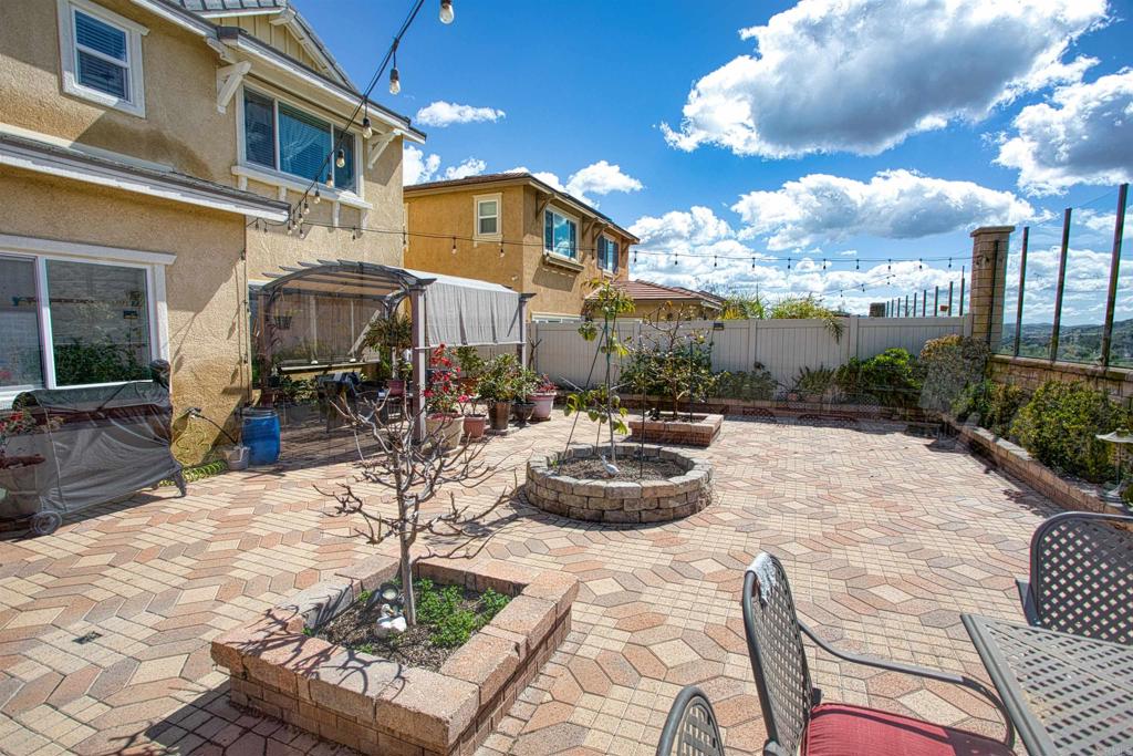 35652 Asturian Way Fallbrook, CA 92028 - Photo 22 of 34 a view of a patio with couches table and chairs and potted plants