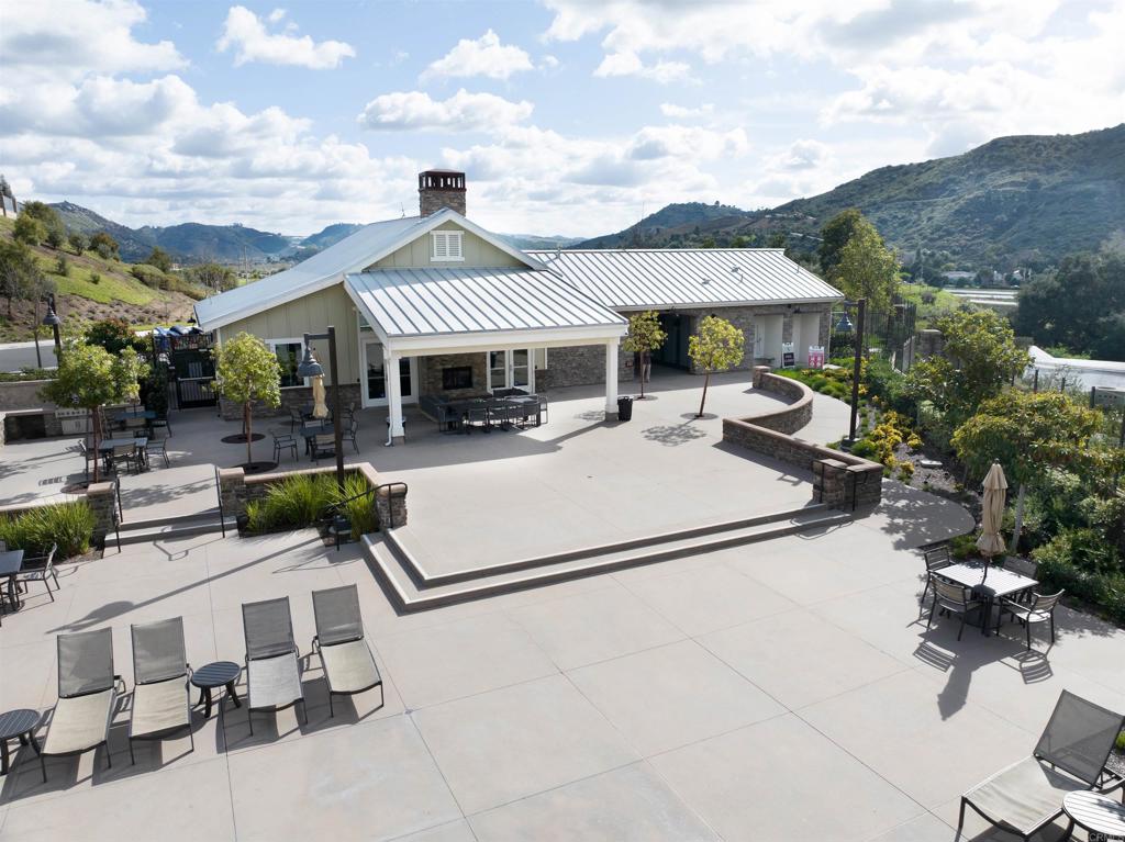 35652 Asturian Way Fallbrook, CA 92028 - Photo 30 of 34 a view of a patio with couches table and chairs under an umbrella