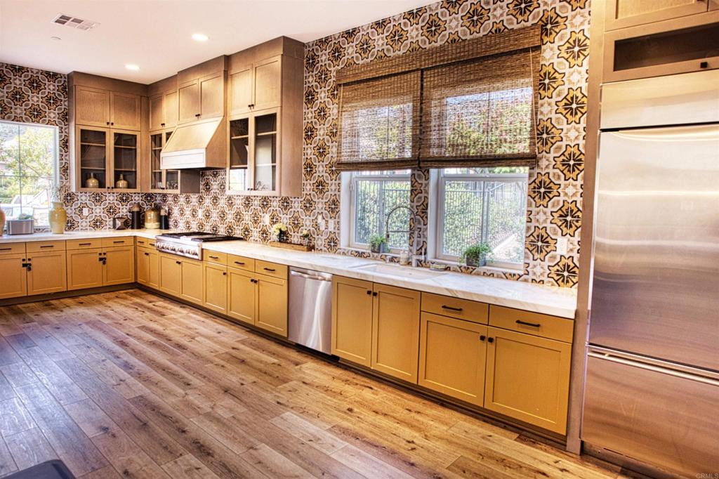 35652 Asturian Way Fallbrook, CA 92028 - Photo 33 of 34 a large kitchen with stainless steel appliances granite countertop a stove and a large window