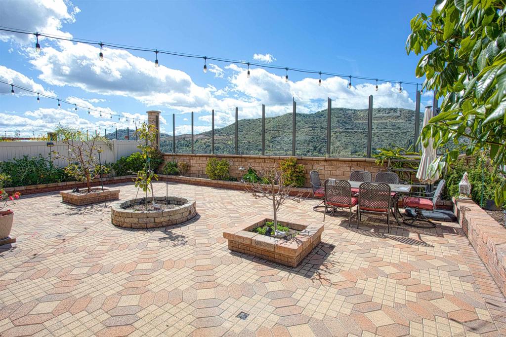 35652 Asturian Way Fallbrook, CA 92028 - Photo 6 of 34 a view of a patio with a dining table and chairs