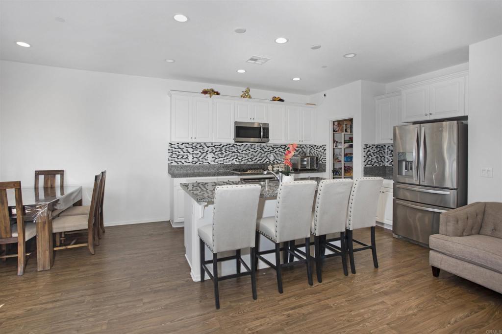 35652 Asturian Way Fallbrook, CA 92028 - Photo 7 of 34 a view of a dining room with furniture and wooden floor