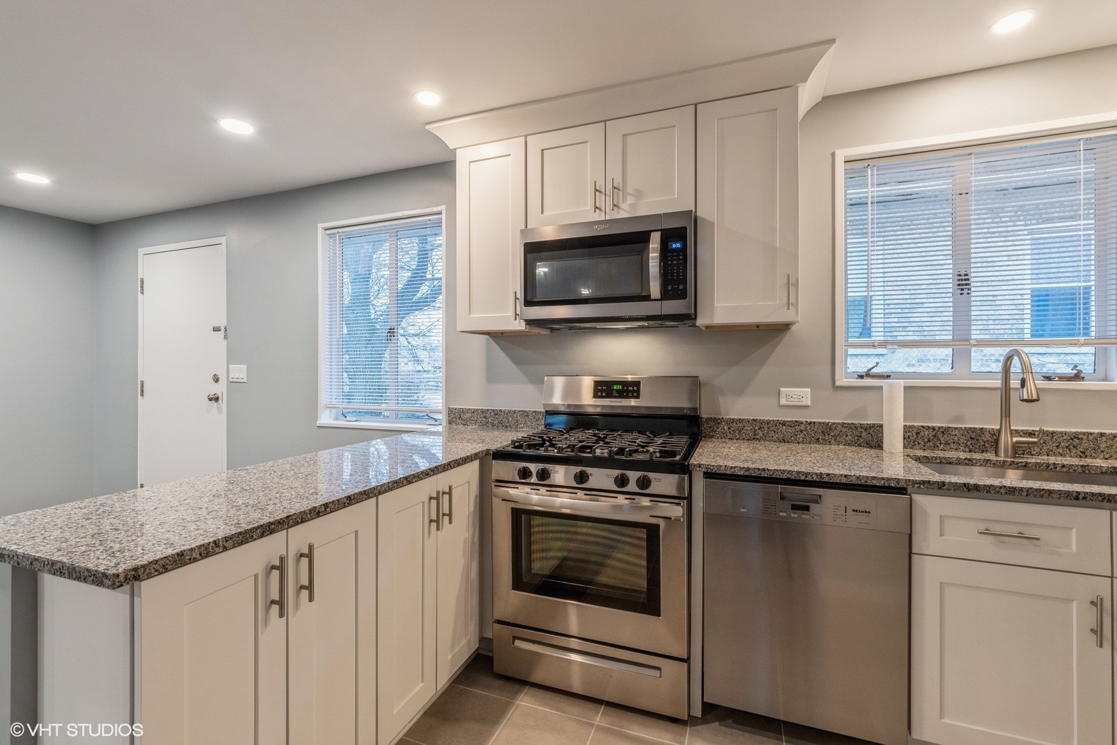 1970 Green Bay Road, Unit B3 Highland Park, IL 60035 - Photo 10 of 11 a kitchen with granite countertop white cabinets and appliances