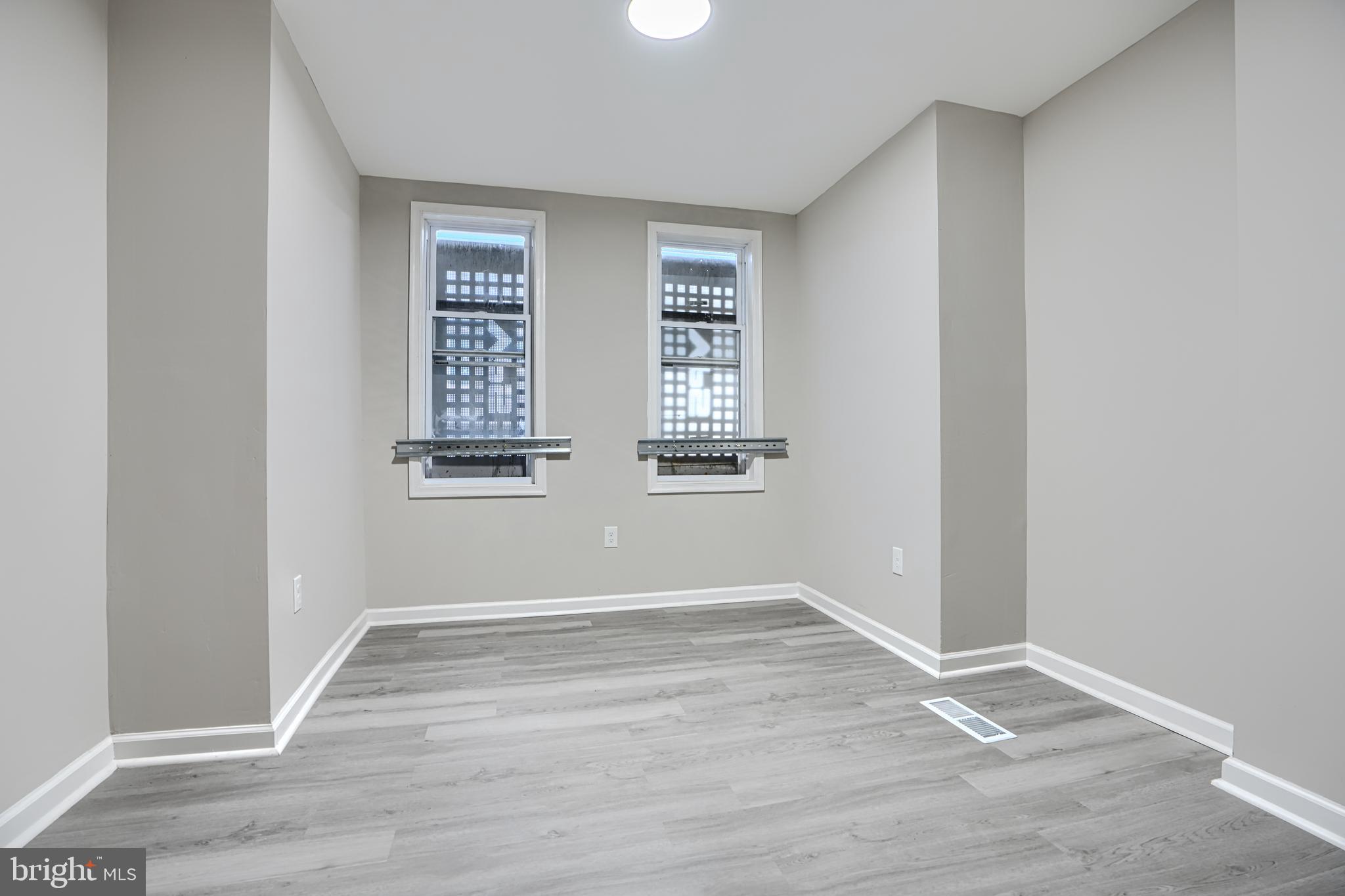 717 North Streeper Street Baltimore, MD 21205 - Photo 12 of 29 an empty room with wooden floor and windows