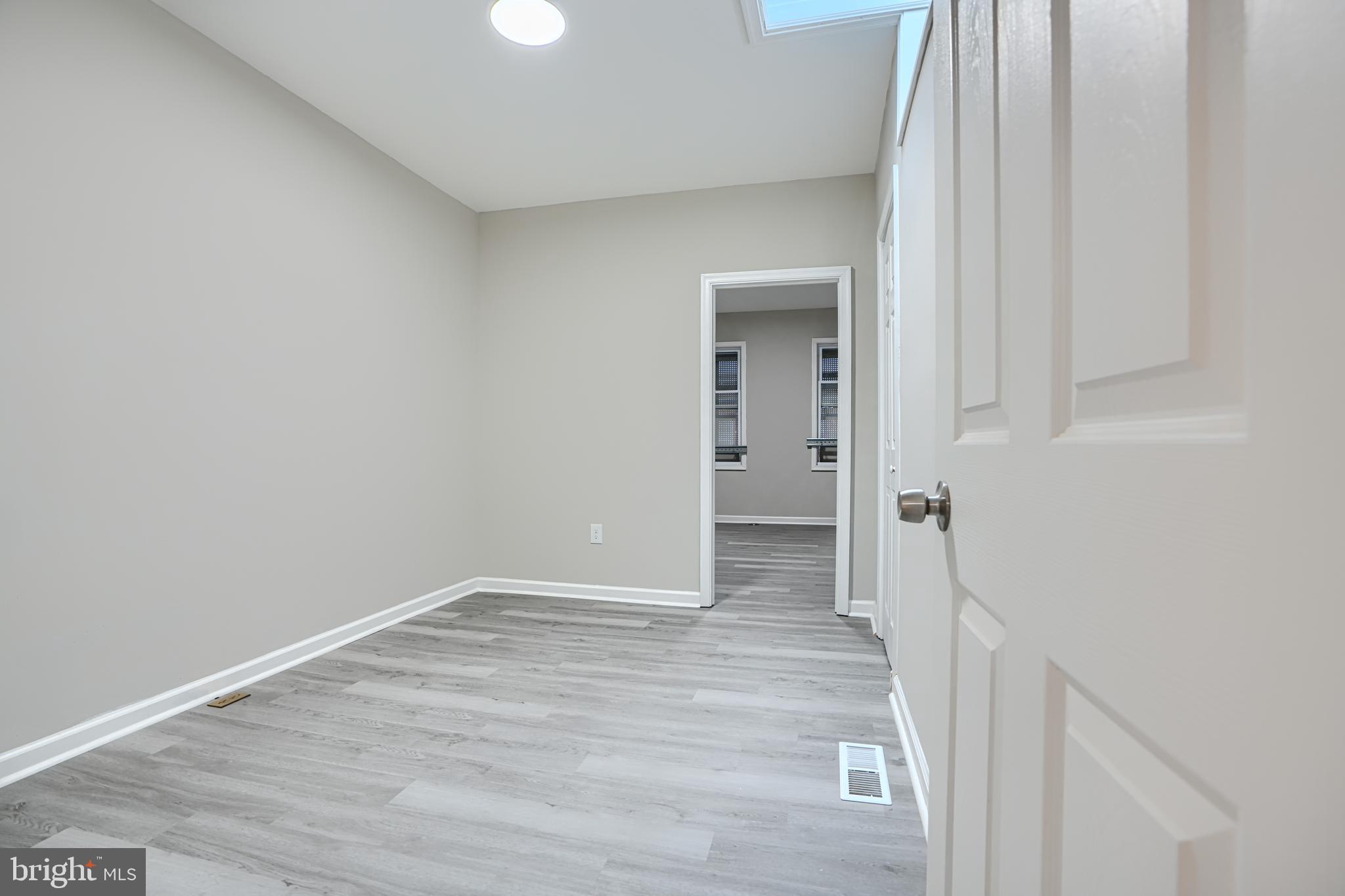717 North Streeper Street Baltimore, MD 21205 - Photo 15 of 29 a view of an empty room with wooden floor