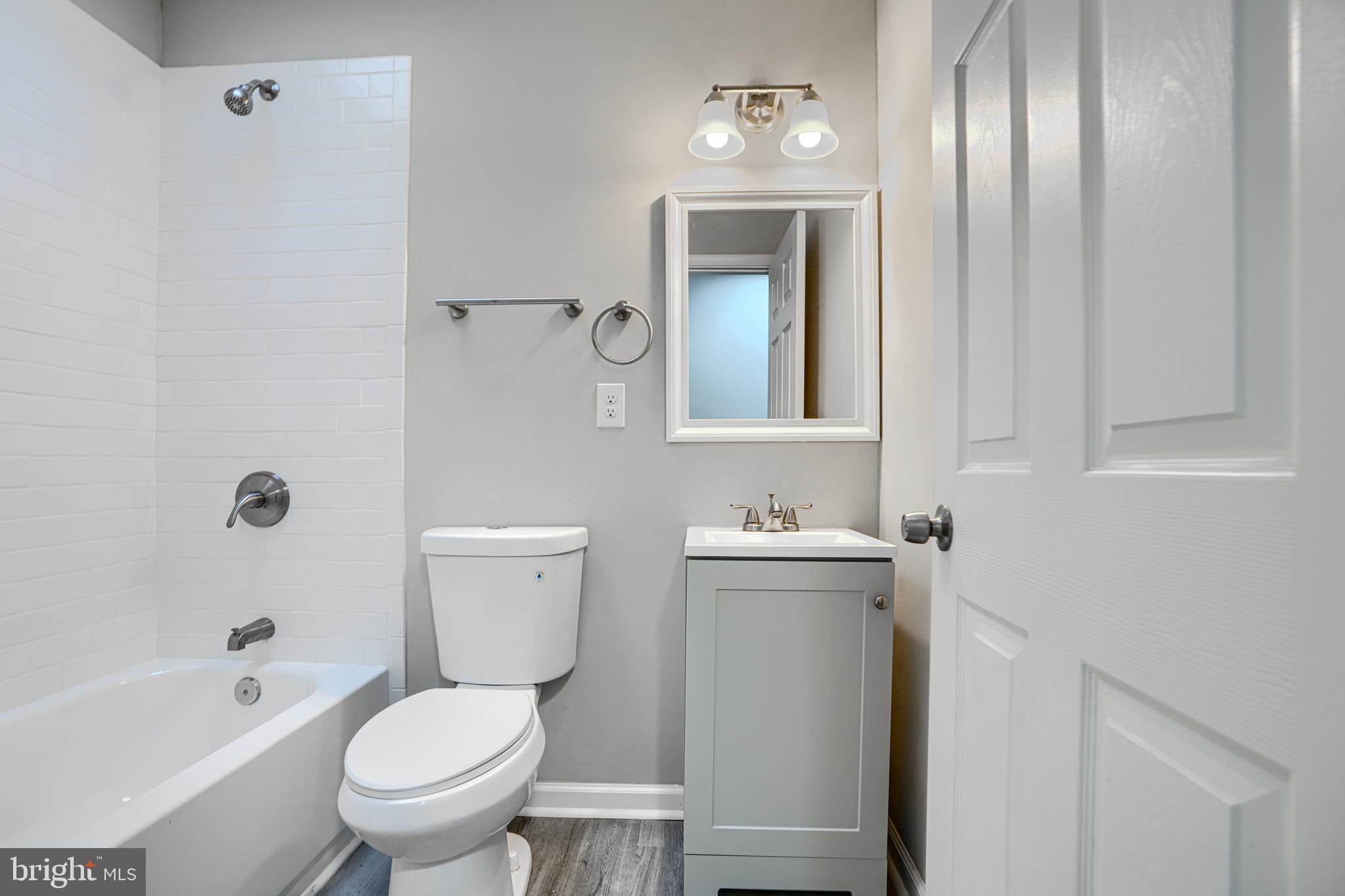 717 North Streeper Street Baltimore, MD 21205 - Photo 18 of 29 a bathroom with a toilet sink and mirror