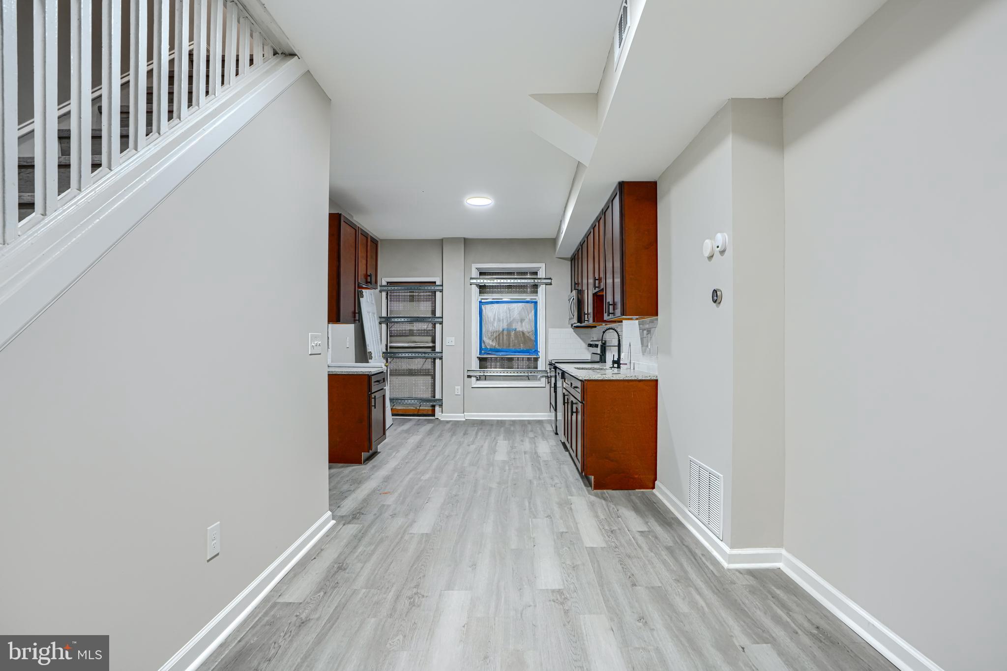 717 North Streeper Street Baltimore, MD 21205 - Photo 5 of 29 a view of kitchen with cabinets and wooden floor