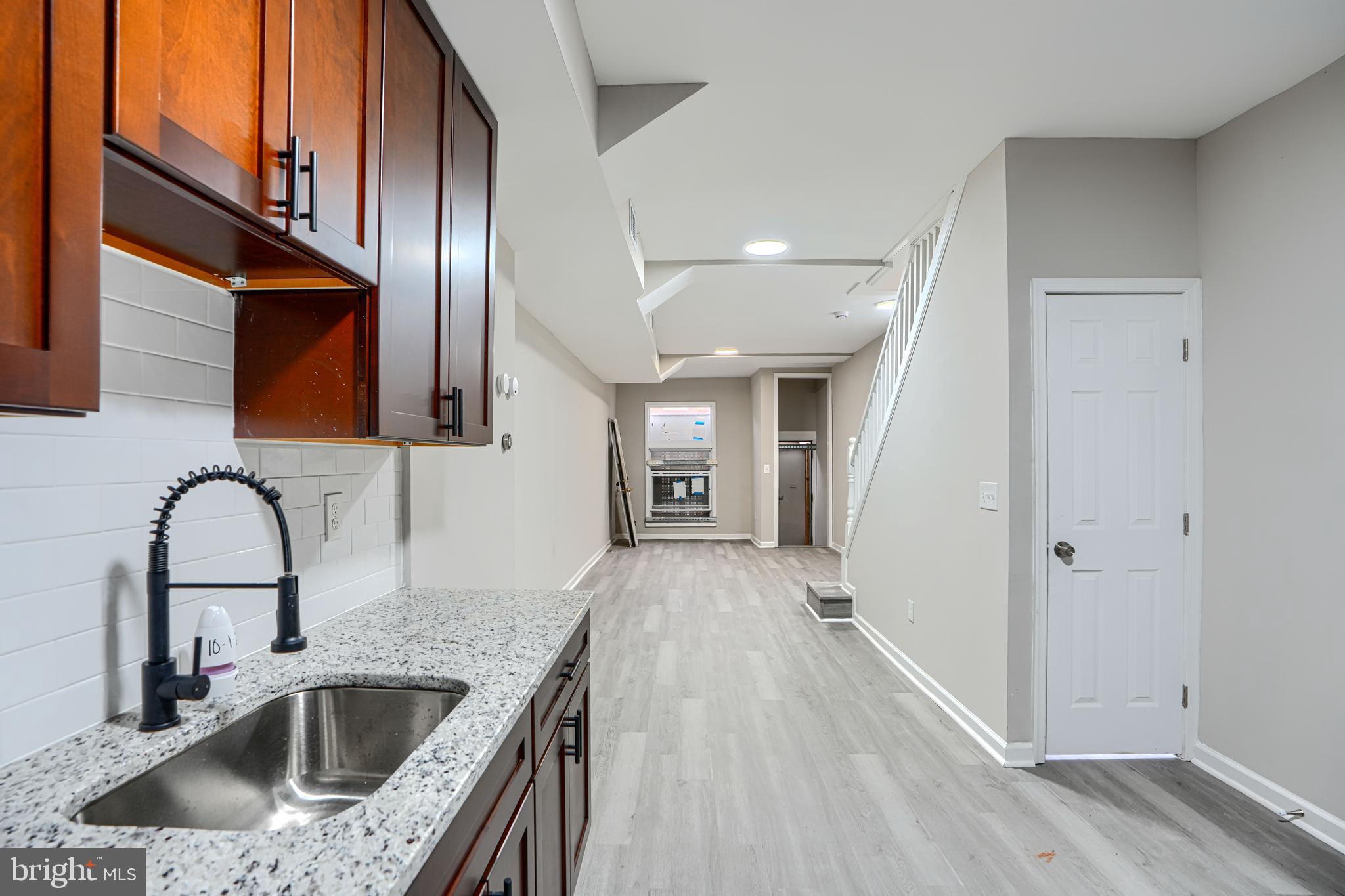 717 North Streeper Street Baltimore, MD 21205 - Photo 10 of 29 a kitchen with a sink and a refrigerator