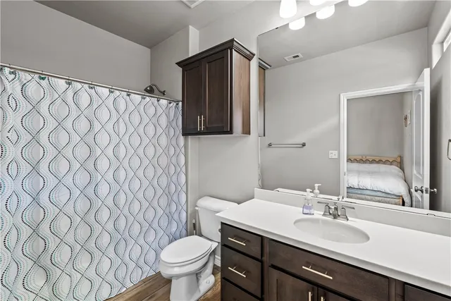 a bathroom with a sink toilet and mirror