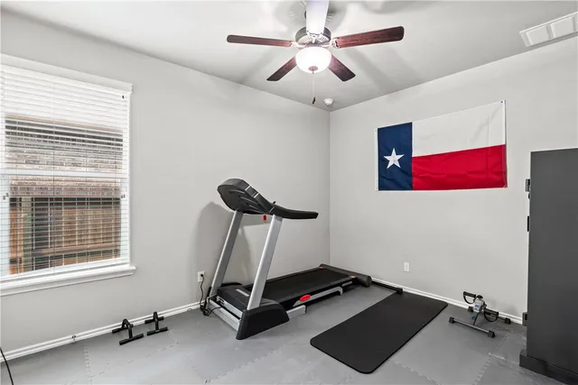 a room with gym equipment and a window