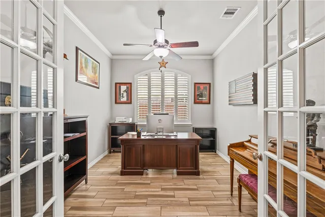 a living room with furniture a fireplace and a chandelier