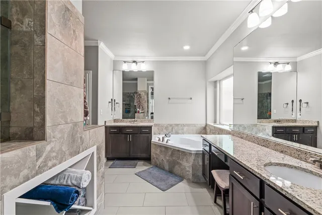 a large bathroom with a granite countertop sink mirror and bathtub