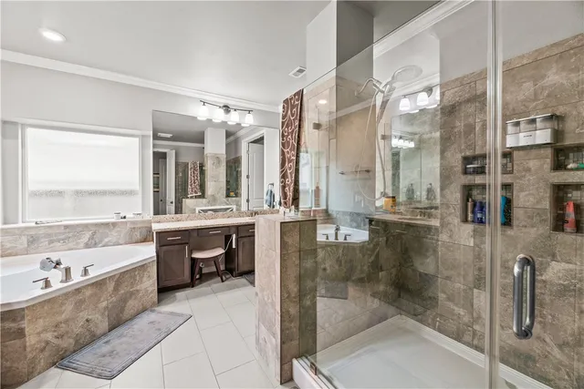 a bathroom with a tub sink shower and mirror