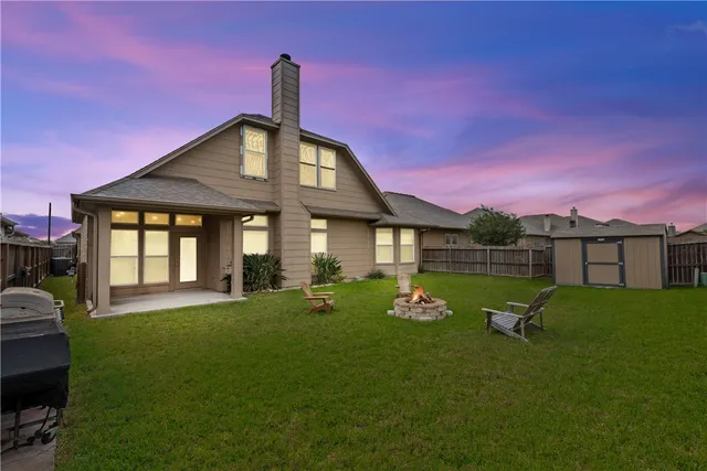 a swimming pool with barbeque oven in front of it