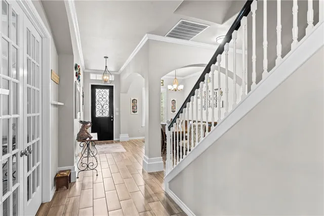 a view of entryway and hall with wooden floor