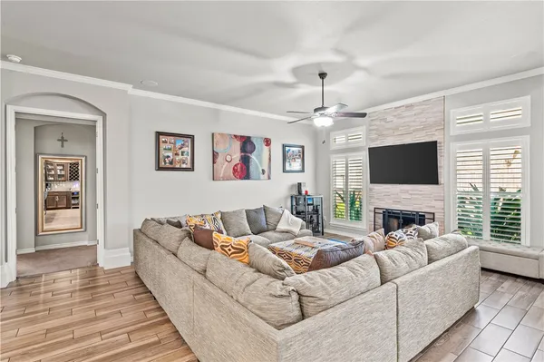 a living room with furniture fireplace and flat screen tv